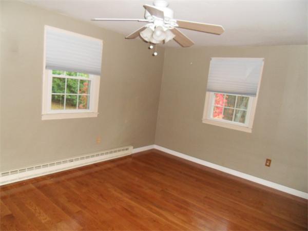 650 Fowler Road Northbridge, MA 01534 - Photo 10 of 15 a view of an empty room with wooden floor and a window