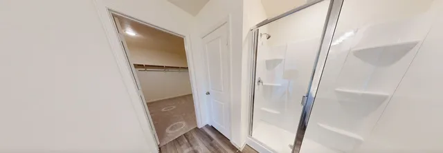 a bathroom with a glass door shower