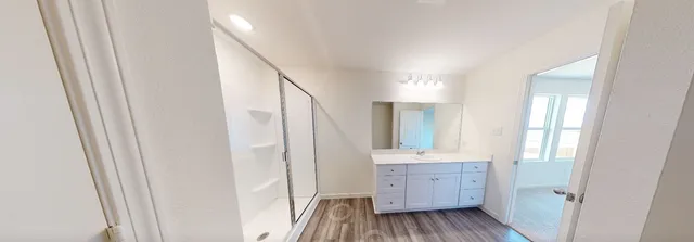 a view of a kitchen from the hallway with a window