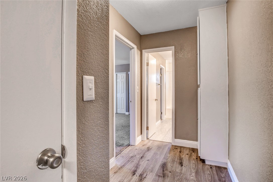 4367 South Mojave Road Las Vegas, NV 89121 - Photo 34 of 53 Wood flooring seamlessly guides the way through this well-designed interior hallway.