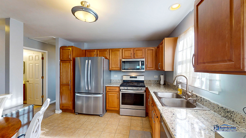746 Legend Lane McHenry, IL 60050 - Photo 10 of 51 a kitchen with granite countertop stainless steel appliances a stove sink and refrigerator
