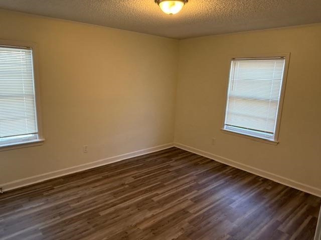 3191 Clarendon Road Memphis, TN 38118 - Photo 11 of 12 a view of an empty room with wooden floor and a window