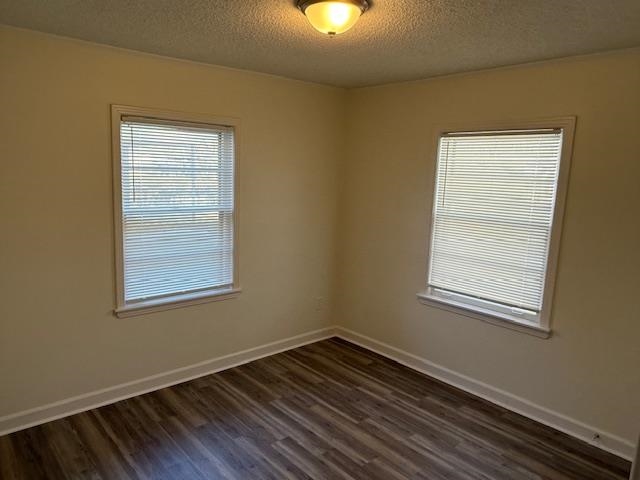 3191 Clarendon Road Memphis, TN 38118 - Photo 12 of 12 a view of an empty room with wooden floor and a window