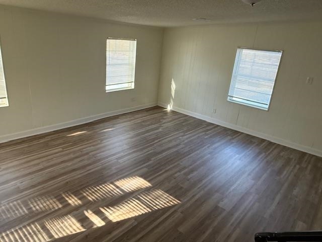 3191 Clarendon Road Memphis, TN 38118 - Photo 6 of 12 a view of an empty room with wooden floor and a window
