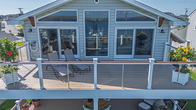 a front view of a house with a yard and potted plants