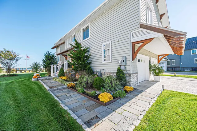 a view of a house with a big yard and large trees