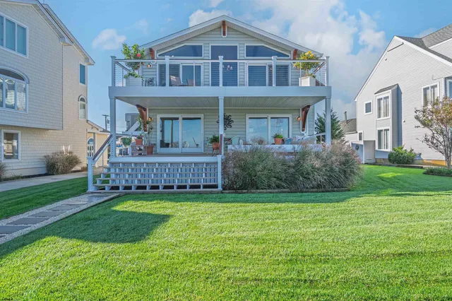 a view of a rooftop deck and dining room with furniture
