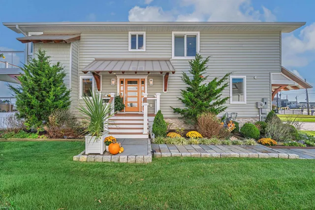 a living room with furniture a chandelier and a dining room