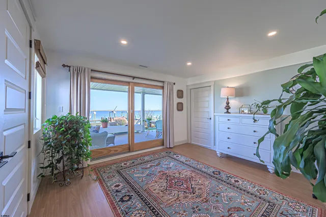 a view of a dining room with furniture a chandelier and wooden floor