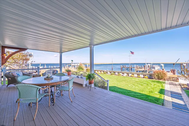 a kitchen with a sink and chairs