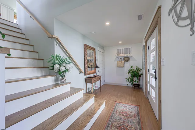 a kitchen with granite countertop a table chairs stove and wooden floor