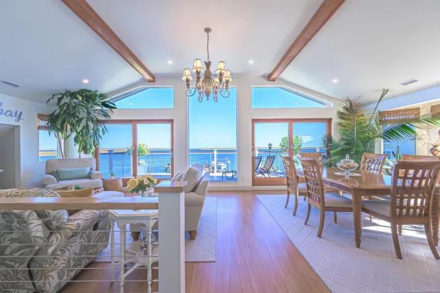 a kitchen with stainless steel appliances granite countertop wooden floor dining table and chairs