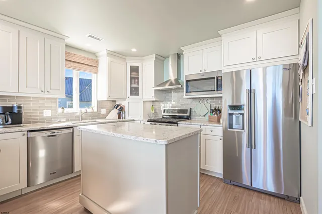 a view of a balcony with chairs and a potted plant