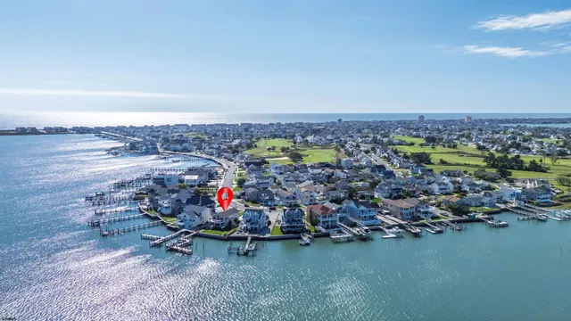 an aerial view of a swimming pool with outdoor seating