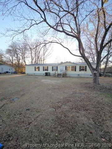a view of large trees with a yard