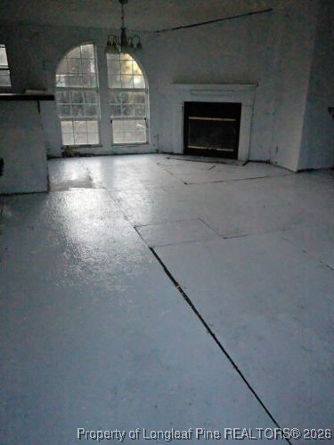 2524 Carriage Road Fayetteville, NC 28312 - Photo 11 of 16 an empty room with windows and fireplace
