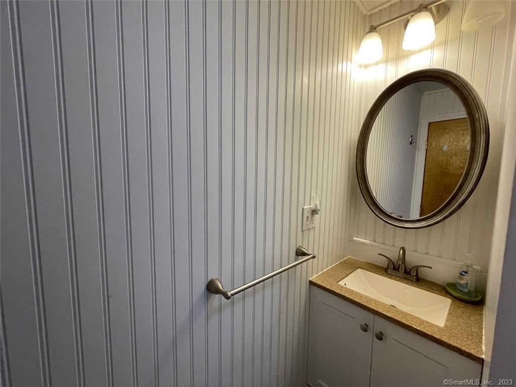 68 Kelsey Place Madison, CT 06443 - Photo 12 of 18 a bathroom with a granite countertop sink and a mirror