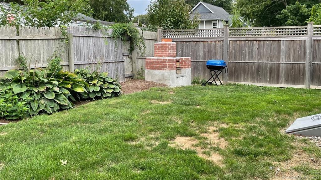 68 Kelsey Place Madison, CT 06443 - Photo 18 of 18 a backyard of a house with table and chairs