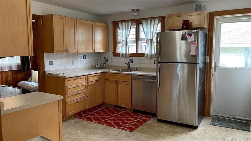 68 Kelsey Place Madison, CT 06443 - Photo 3 of 18 a kitchen with a refrigerator sink and cabinets