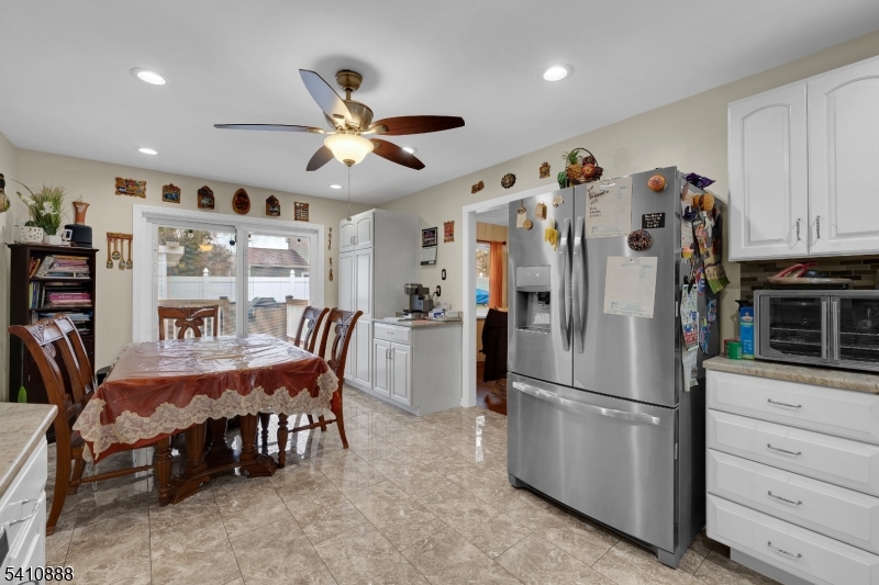 30 General Lane Willingboro, NJ 08046 - Photo 12 of 22 a kitchen with stainless steel appliances kitchen island granite countertop a refrigerator a stove a dining table and chairs with wooden floor