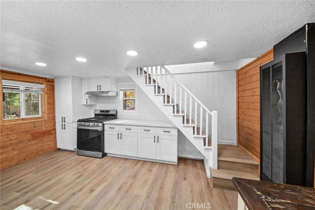 180 Glen Avon Drive Cedar Glen, CA 92321 - Photo 13 of 24 a view of a kitchen with wooden floor electronic appliances and stairs