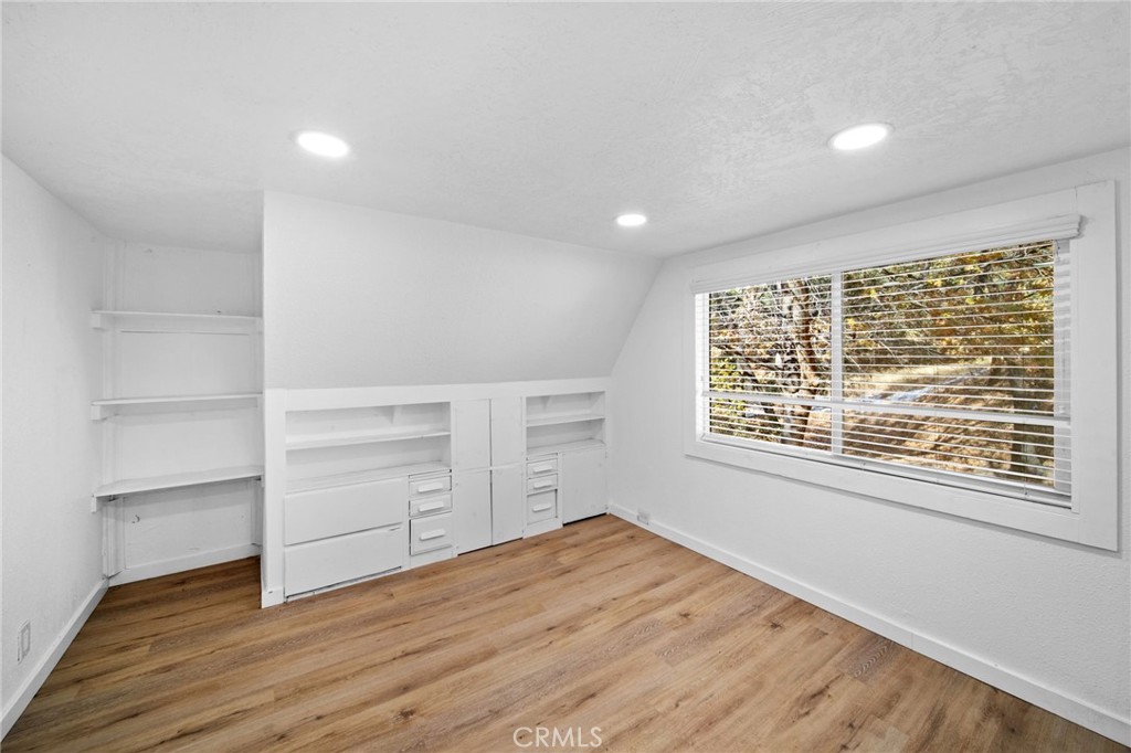 180 Glen Avon Drive Cedar Glen, CA 92321 - Photo 17 of 24 a view of an empty room with a window and wooden floor