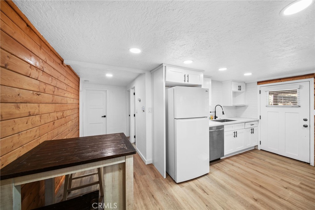 180 Glen Avon Drive Cedar Glen, CA 92321 - Photo 8 of 24 a kitchen with a sink stainless steel appliances wooden floor and cabinets