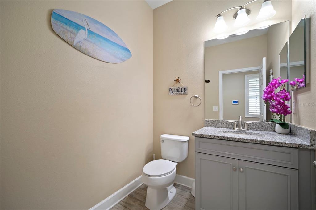 5807 Circa Fishhawk Boulevard Lithia, FL 33547 - Photo 11 of 40 a bathroom with a granite countertop sink vanity mirror and toilet