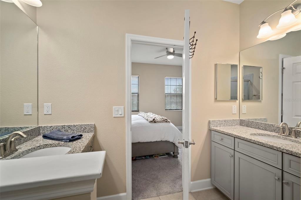 5807 Circa Fishhawk Boulevard Lithia, FL 33547 - Photo 15 of 40 a en suite bathroom with a double vanity sink and mirror
