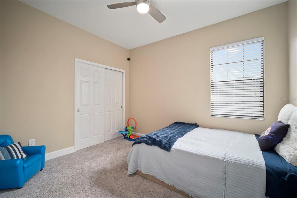 5807 Circa Fishhawk Boulevard Lithia, FL 33547 - Photo 21 of 40 a bedroom with a bed and a window