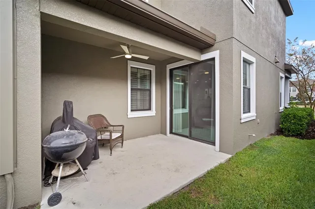 a backyard of a house with table and chairs