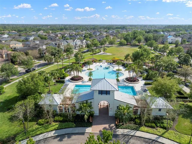 an aerial view of a house with outdoor space and a lake view
