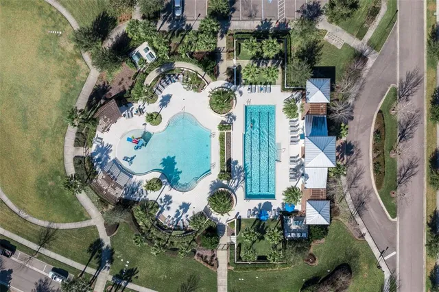 an aerial view of a residential houses with yard