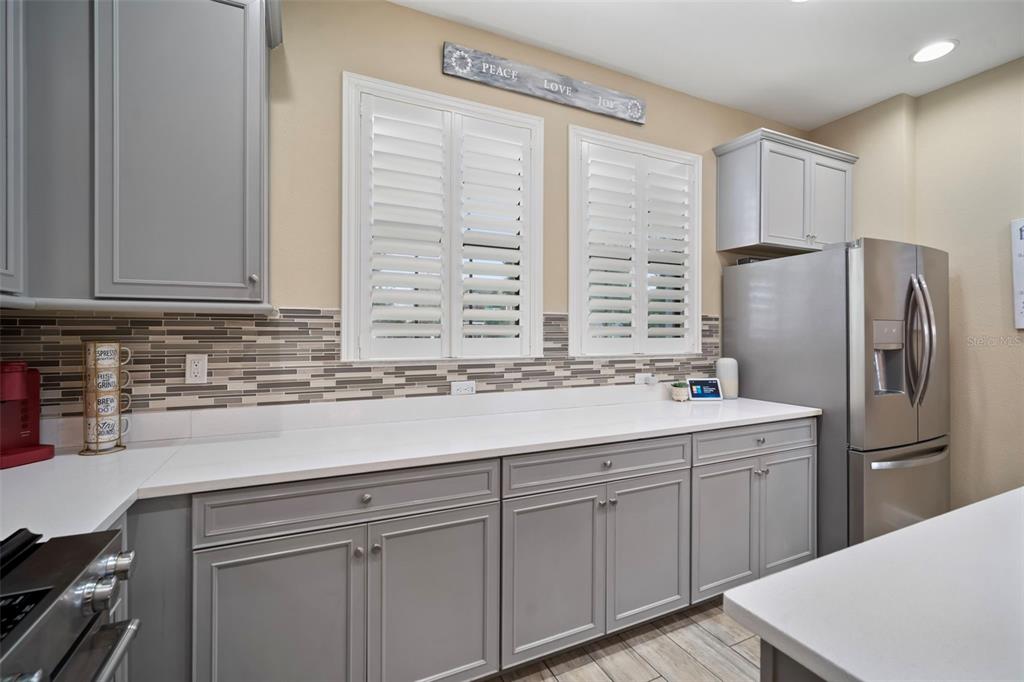 5807 Circa Fishhawk Boulevard Lithia, FL 33547 - Photo 4 of 40 a kitchen with stainless steel appliances granite countertop a sink a refrigerator and a stove