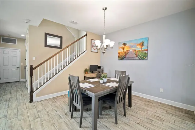 a view of a dining room with furniture wooden floor and chandelier