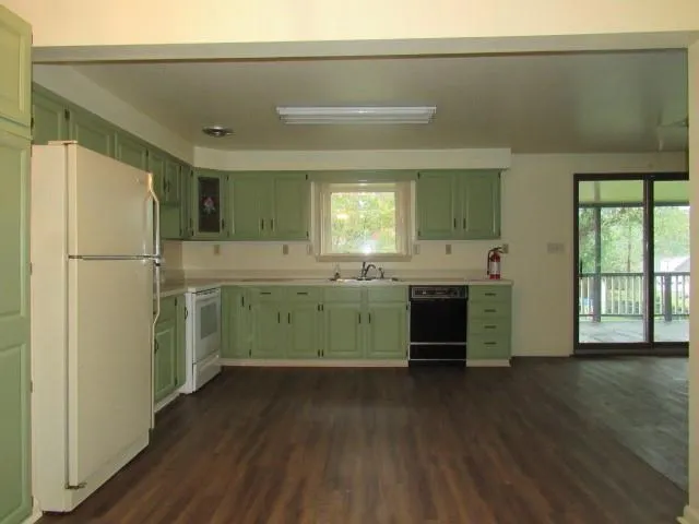 a kitchen with a refrigerator sink and cabinets