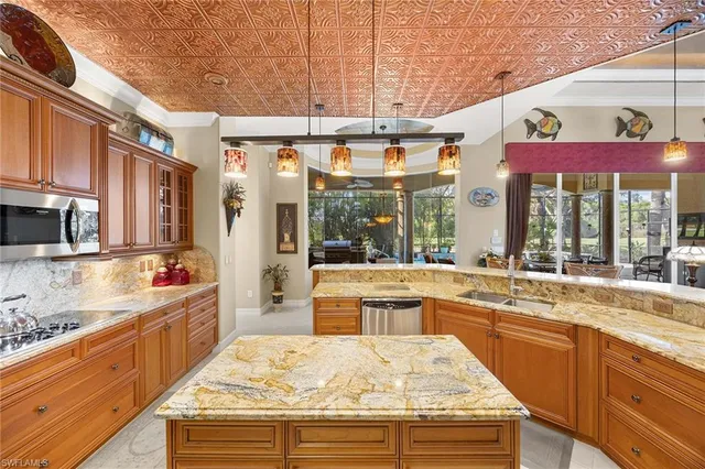 a large kitchen with stainless steel appliances granite countertop a lot of counter space and a large window