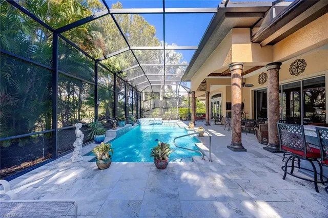 a dining hall with living room and couches a fireplace with wooden floor