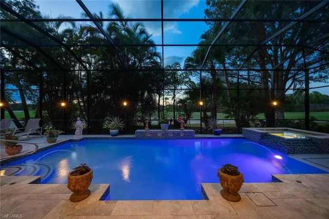 a view of a swimming pool with outdoor seating