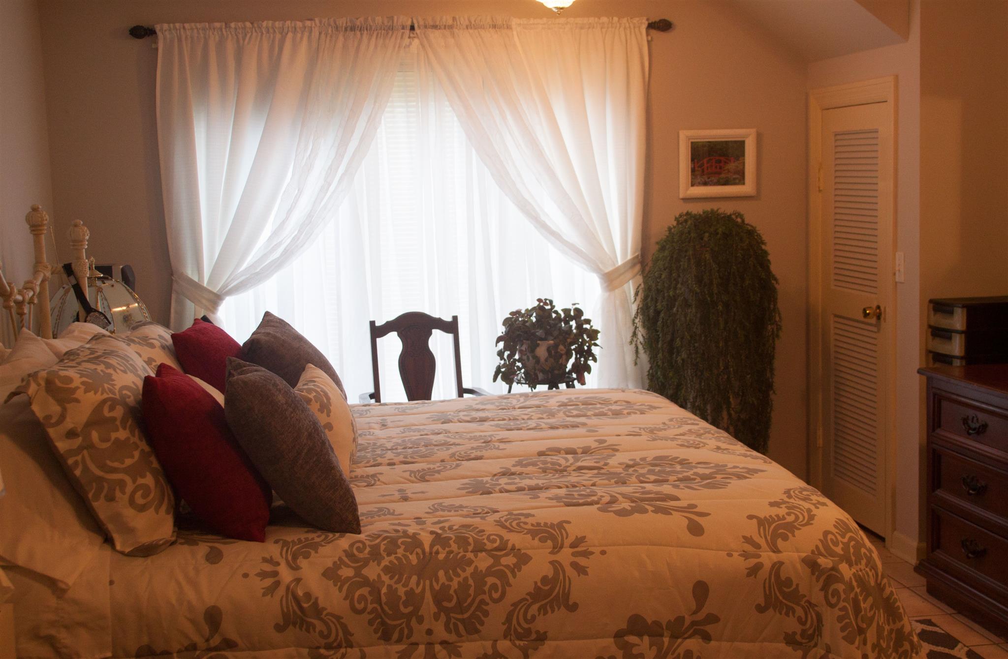 3932 Pleasant Grove Road White House, TN 37188 - Photo 7 of 14 a bed sitting in a bedroom next to a window and a mirror