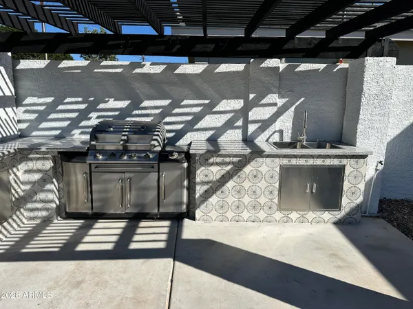 a kitchen with stainless steel appliances granite countertop a sink and cabinets