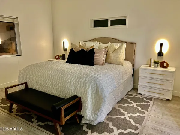 a bedroom with a bed and a lamp