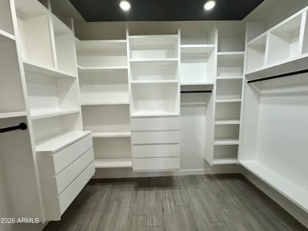 a living room with furniture and a dining table with kitchen view