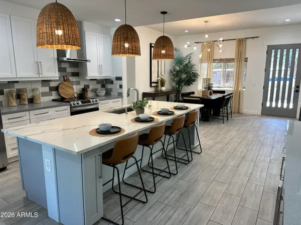 a view of a dining room with furniture and a chandelier