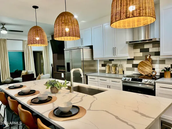a kitchen with stainless steel appliances a sink a stove and a wooden floors