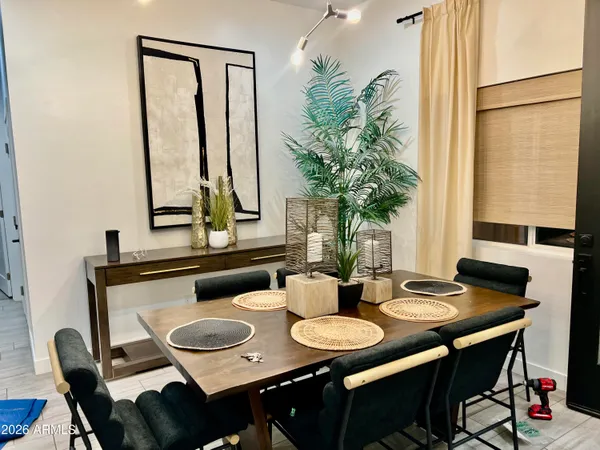 a living room with furniture kitchen view and a chandelier