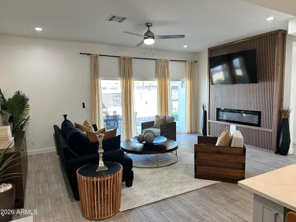 a kitchen with granite countertop white cabinets white appliances with a sink and a window