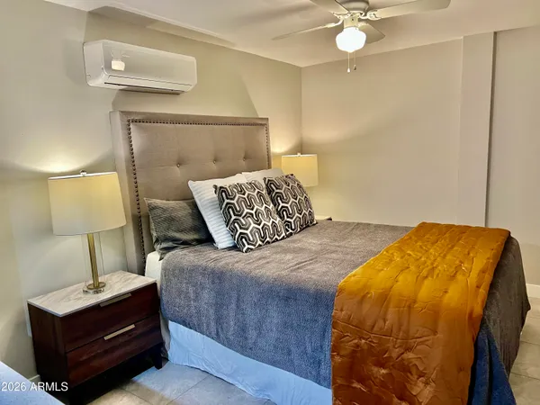 a living room with furniture and a floor to ceiling window