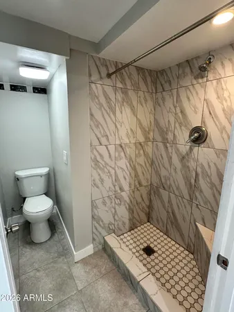 a view of a backyard with plants and outdoor seating