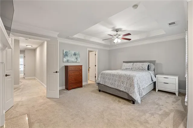 a spacious bedroom with a bed and a chandelier
